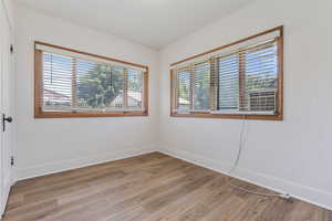 Spare room with light wood-style flooring and cooling unit