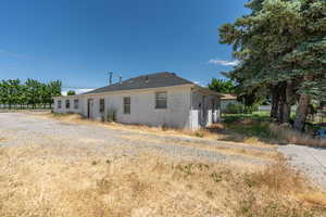Rear view of property with concrete block siding