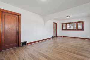 Unfurnished room with light wood-type flooring and arched walkways