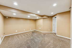 Finished basement with recessed lighting and carpet floors