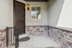 Entrance to property with stucco siding