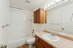 Full bathroom with shower / bathtub combination, vanity, and dark tile patterned flooring