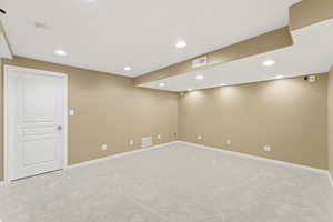 Unfurnished room with light carpet and recessed lighting