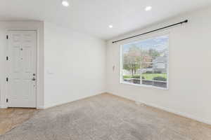 Unfurnished room with light colored carpet and recessed lighting