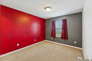 Carpeted empty room with baseboards