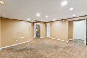 Spare room featuring recessed lighting and carpet floors