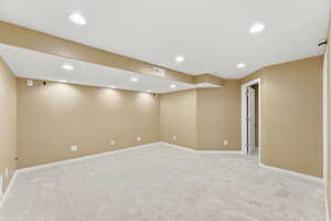 Finished below grade area with light carpet and recessed lighting