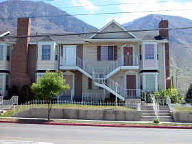 View of front facade with a mountain view, a chimney, and a fenced front yard