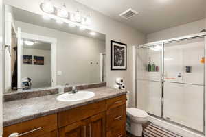 Primary bathroom with vanity and a shower stall