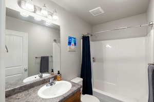 Full bath featuring vanity and shower / tub combo with curtain