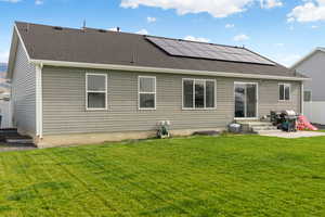 Back of property featuring roof mounted solar panels, roof with shingles, and entry steps