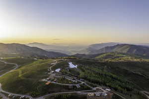 View of mountain backdrop featuring a nearby body of water