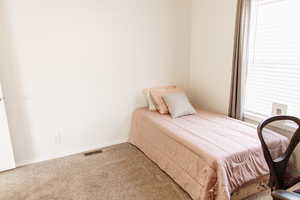 Carpeted bedroom featuring baseboards