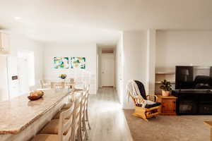 Dining room featuring light wood-type flooring and recessed lighting