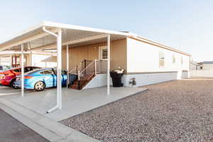 View of parking featuring an attached carport