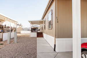View of side of property featuring a wooden deck