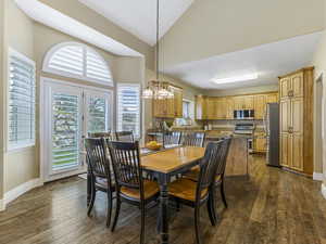 Dining space with a chandelier and high vaulted ceiling