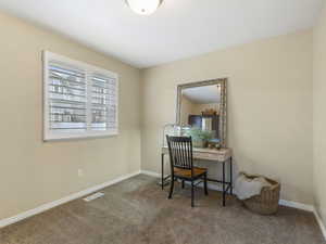 Bedroom with dark colored carpet