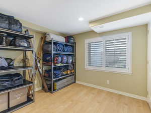Basement bedroom with hardwood floors and recessed lighting