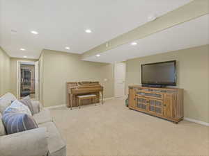 Living room featuring recessed lighting and light colored carpet