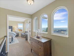 Hallway featuring an upstairs landing with large windows with valley views