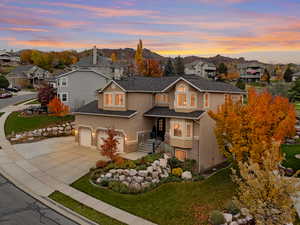 Traditional-style house with stucco and brick siding, three car garage and valley and mountain views