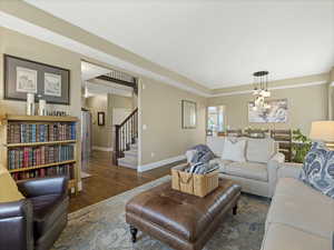 Living area with stairway and wood finished floors