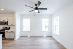 Kitchen with stainless steel appliances, tasteful backsplash, light wood finished floors, ceiling fan, and recessed lighting