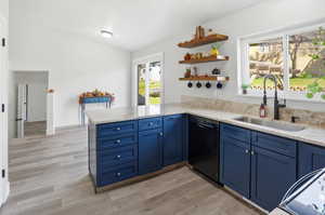 Kitchen with a peninsula, blue cabinets, light granite countertops, black dishwasher, and new LVP floors