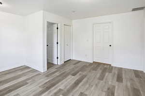 Door to small stairway to kitchen, access to crawl space, laundry room door