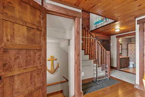 Stairs with wood finished floors and wood ceiling