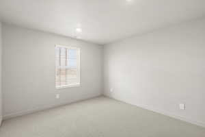 Unfurnished room featuring carpet floors and baseboards