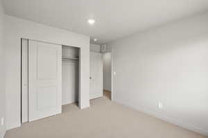 Unfurnished bedroom featuring carpet, a closet, and recessed lighting
