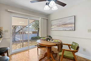 Dining room featuring a ceiling fan and baseboards