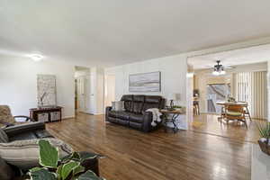Living area with wood finished floors and ceiling fan