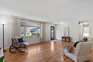Living area with light wood-style floors and baseboards