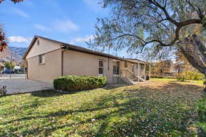 Back of property featuring brick siding and a gate
