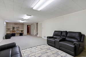 Living room featuring carpet and stairway