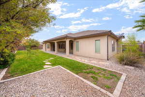 Back of house featuring stucco siding and a patio area