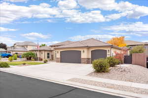 Single story home featuring a garage, a gate, stucco siding, driveway, and a tile roof