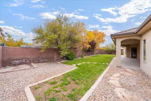 Fenced backyard featuring a patio