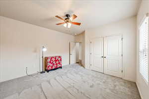 Unfurnished bedroom with carpet floors, a ceiling fan, and a closet