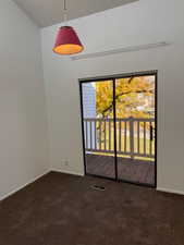Bedroom room with dark carpet and a textured ceiling
