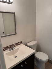 Bathroom featuring vanity, tile patterned flooring, and backsplash