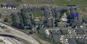 Aerial view of property's location with nearby suburban area