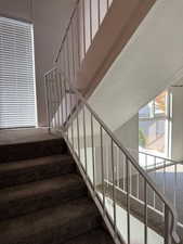 Staircase featuring a textured ceiling