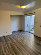 Downstairs family room with a textured ceiling and wood finished floors