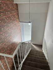 Stairway featuring carpet floors