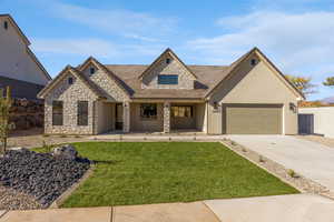 View of front facade with covered porch, concrete driveway, stone siding, stucco siding, and an attached garage