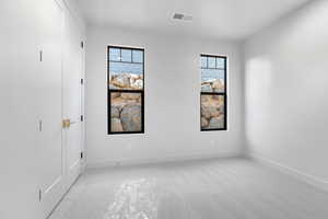 Unfurnished room with light colored carpet